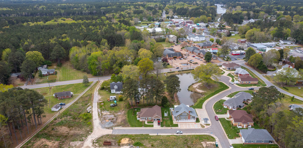 A person working remotely on a laptop with natural light and waterfront view